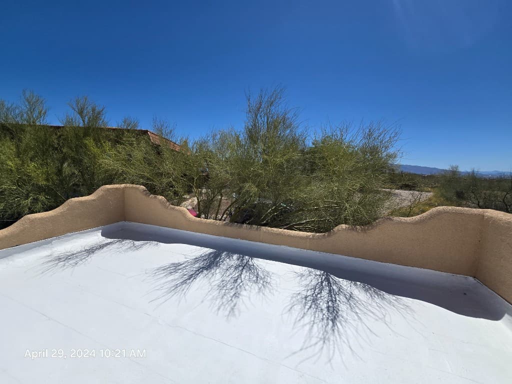 Inspector roof photo showing a clean white roof membrane next to a tan parapet wall