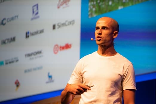 SwiftReporter Co-Founder Evan Sutter delivers a keynote talk on stage 